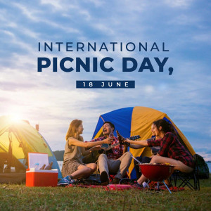 People enjoying a picnic with a tent and campfire