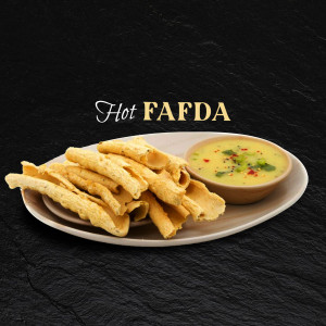 A plate of crispy Fafda served with a side of chutney