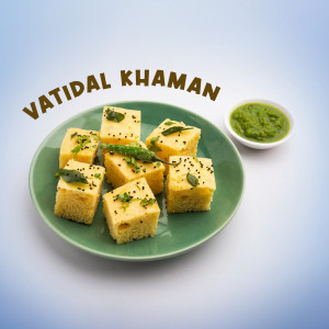 Close-up of Vatidal Khaman, a savory Gujarati snack, served on a green plate with chutney.