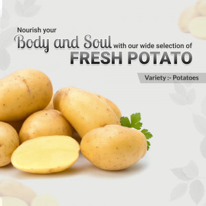 Pile of fresh potatoes with a cut potato showing the inside