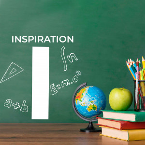 School supplies arranged on a wooden surface with a chalkboard background