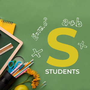 Top-down view of school supplies with math equations and the letter 'S' for students on a green chalkboard background.