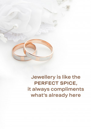 Close-up of two wedding rings, one gold and one silver, on a white flower background.