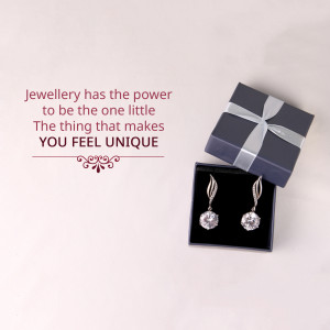 Silver earrings in a gift box with text 'Jewellery has the power to be the one little thing that makes you feel unique'