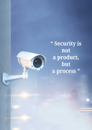 A white security camera mounted on a wall with a motivational quote about security.