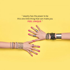 Hands adorned with various bracelets and rings against a yellow background with a motivational quote.