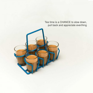 A blue tea glass holder with six glasses of tea.