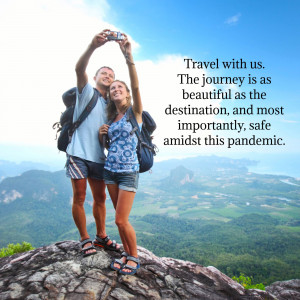 A couple taking a selfie while hiking in the mountains with a scenic view.