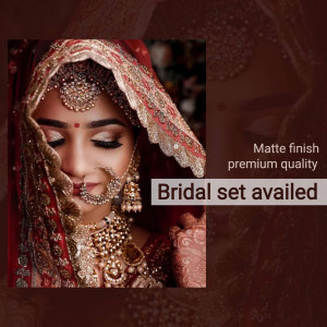 Close-up of an Indian bride wearing traditional jewelry and a red veil.
