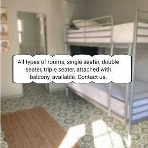 Interior view of a hostel room with bunk beds and tiled floor.