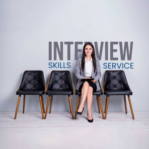 Woman sitting in a waiting area with 'Interview' sign