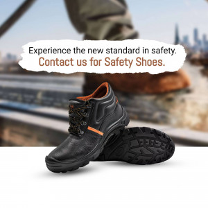 Close-up of black and orange safety shoes with a blurred city background and text promoting safety footwear.