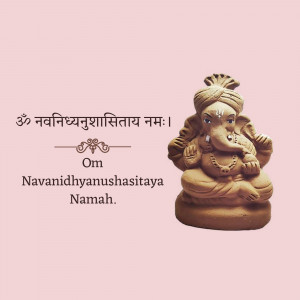 A terracotta statue of Lord Ganesha with a mantra inscription.