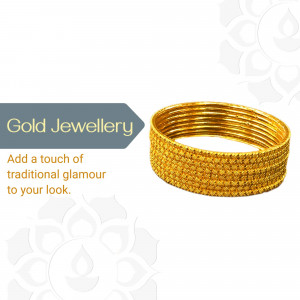 Stack of golden bangles on a white background