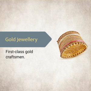 Close-up of intricately designed gold bangles with red stone accents