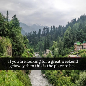 Lush green mountains and a river with a small village