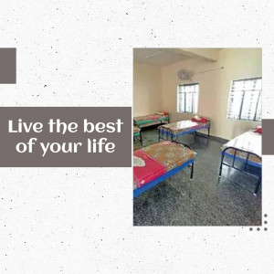 A simple hostel room with beds and a motivational quote.