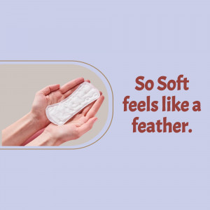 Hands holding a So Soft sanitary pad against a lavender background.