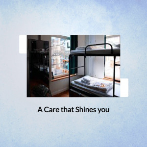 Interior view of a hostel room with bunk beds and a window