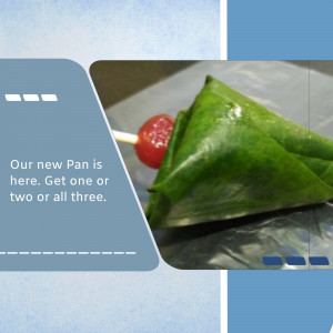 A close-up of a traditional Indian Pan (betel leaf preparation) with a bright red candy.