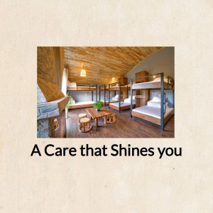 Interior view of a clean and well-lit hostel dormitory with bunk beds.