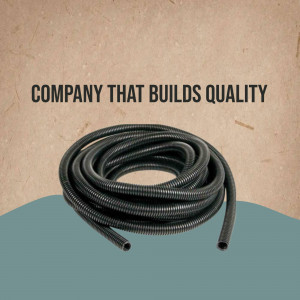 Black corrugated hose coiled on a blue and brown background