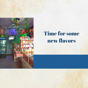 Interior view of an ice cream shop with colorful decorations and a display of flavors.