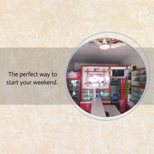 Interior view of a small shop with shelves and a refrigerator