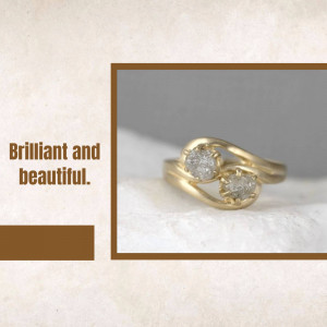 Close-up of a gold ring with two raw diamonds