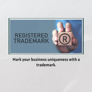 Hand holding a cube with a registered trademark symbol on it.
