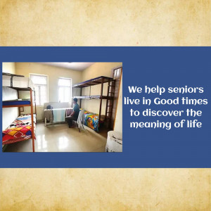 Interior view of a room in a senior living facility with bunk beds and a resident.