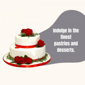 Two-tiered white wedding cake decorated with red roses and green leaves.