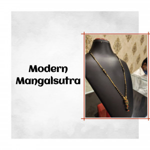 Close-up of a modern gold mangalsutra on a black jewelry bust.