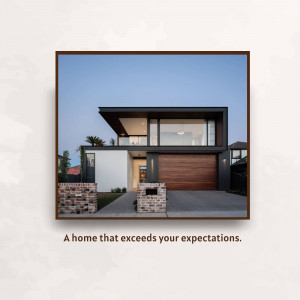 A modern, two-story house with a dark frame and light-colored walls.