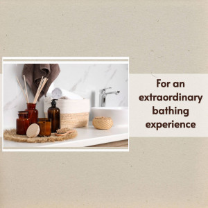 Bathroom scene with reed diffusers, soap, and rolled towels on a white countertop.