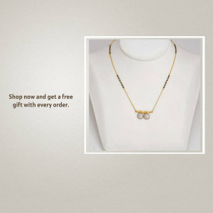 Close-up of a delicate gold mangalsutra with pearl pendants on a white background.