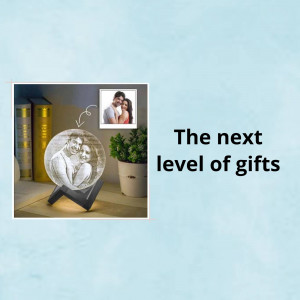 3D photo crystal with a couple's image, displayed on a shelf with a plant and books