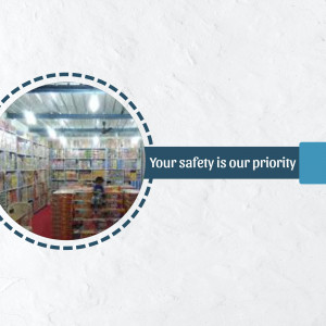 Interior view of a bookstore with shelves full of books and a safety message.