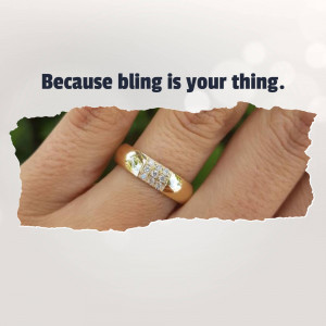 Close-up of a gold ring with small diamonds on a finger