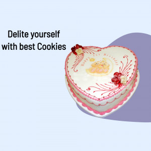 A heart-shaped cake decorated with cookies and frosting, with the text 'Delite yourself with best Cookies'