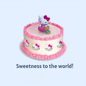 A round white cake decorated with Hello Kitty images and a Hello Kitty figurine with a teddy bear.