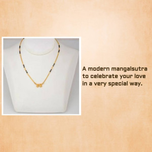 Close-up of a gold and black beaded mangalsutra on a white bust.