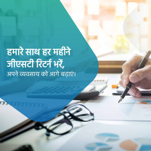 Image depicting GST return filing with a calculator, pen, glasses, and charts.