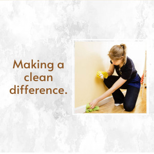 Woman cleaning a wall with a sponge and cleaning solution