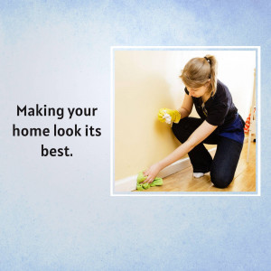 Woman cleaning baseboard with a green sponge