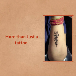 Close-up of a Trishul tattoo on a person's arm