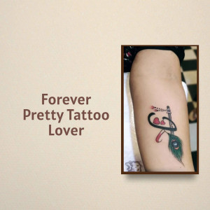 Close-up of a tattoo on a person's arm featuring a heart and feather design.