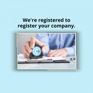 Hand stamping a copyright symbol on documents, representing company registration.