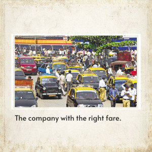 Busy street scene in Mumbai, India with yellow and black taxis