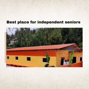A colorful building with a red roof and yellow walls, designed for independent seniors.